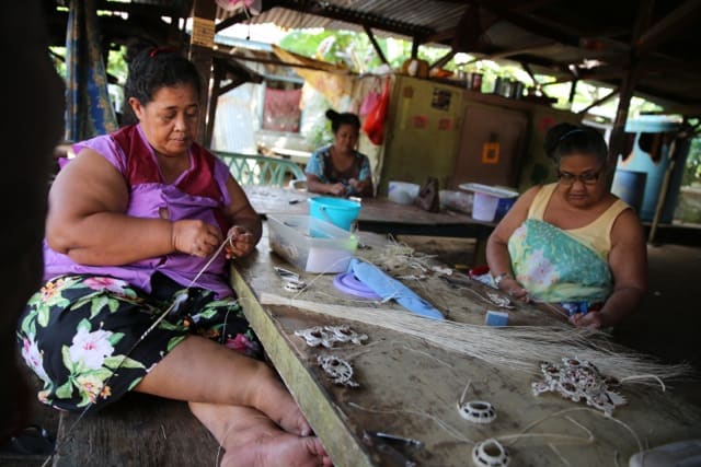Kapingamarangi women in Pohnpei making traditional handicrafts.